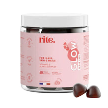 Vegan vitamin gummies bottle with pink label and dark berry gummies beside it