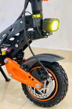 Electric bike front hub and brake area with bright headlight and orange fork