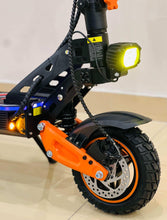 Electric bike front wheel with orange fork, disc brake, and bright headlight