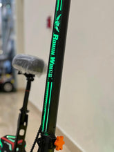 Electric bike frame down-tube close-up with green vertical stripe lettering