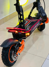 Electric bike rear view with orange accents, red tail lights, and front tire