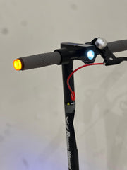 Close-up of RohaN Wings HT04 electric scooter UAE handlebar with lights and grips