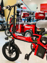 Red folding electric scooter, front-left view with headlamp and RohaN Wings logo