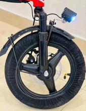 Black and red electric scooter front wheel, fork, and front fender