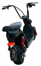 Black electric scooter with cushioned seat, handlebar display, and red spring rear shock