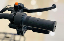 Electric scooter handlebar controls with orange indicator and textured black grips