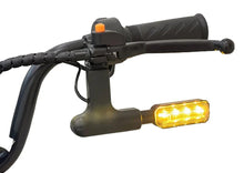Electric scooter handlebar with amber turn signal and black rubber grips