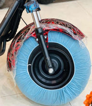 Front wheel with black tire and blue protective cover, silver fork