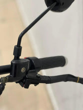 Electric scooter controller area with black handlebar grips and cables