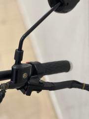 Close-up of RohaN Wings X8 electric scooter UAE handlebars with grip and brake lever