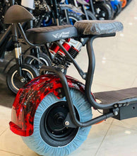 Electric scooter with black seat, red front wheel cover, and blue tire