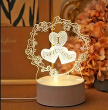 LED heart lamp with heart centerpiece and LOVE YOU words inside floral ring, on white base