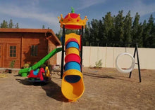 Outdoor playground set with tall slide tower, green slide, and hanging ring swing