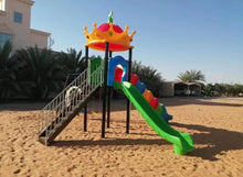 Outdoor playground set with green slide, tube sections, and two hanging swing discs