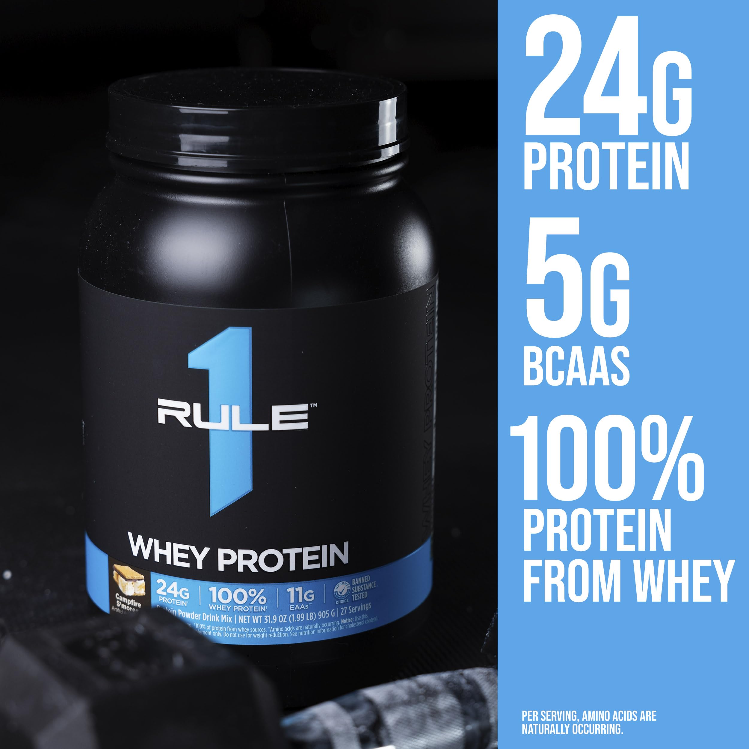 Black Rule 1 whey protein tub labeled Rule1 1 Whey Blend 24g protein next to chocolate pieces and shaker bottle
