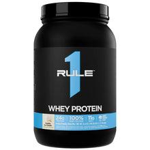 Whey protein powder tub with black lid and blue front label, vanilla ice cream flavor.