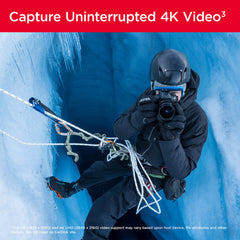 Professional photographer climbing ice cave capturing uninterrupted 4K video with SanDisk 128GB Extreme PRO SD card