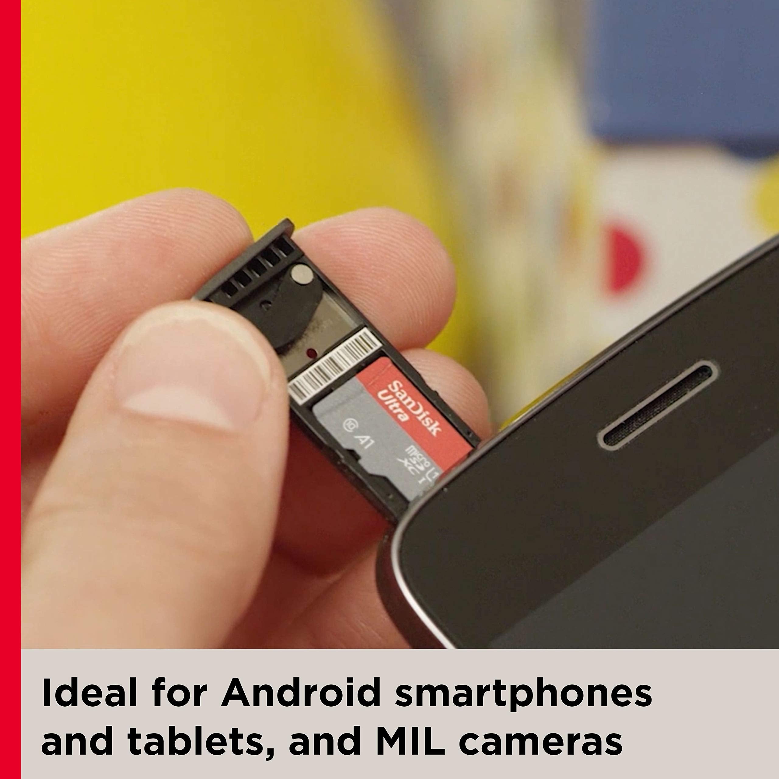 Hand inserting a 256GB memory card for Android phones into a smartphone memory card slot