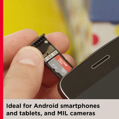 Hand inserting a 256GB memory card for Android phones into a smartphone memory card slot