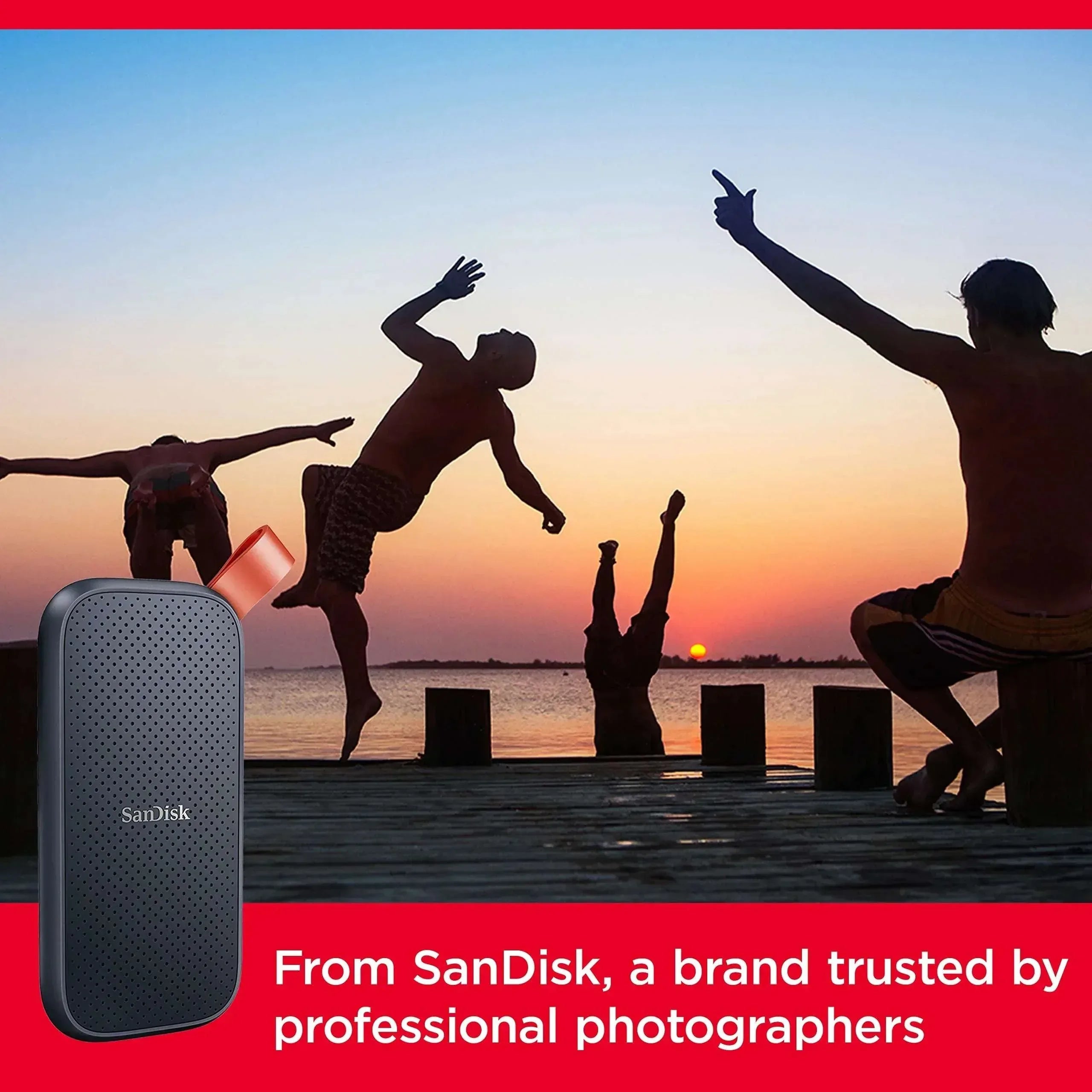 SanDisk external SSD with orange strap in use, cable attached