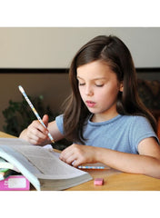 Girl using Sanrio pencil set with accessories while studying at a desk
