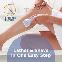 Woman shaving legs in bathtub using Schick Intuition razor refill cartridges for lather free shave in one step