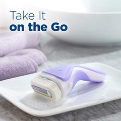Lavender Schick Intuition razor on soap dish with suds and towel by sink Schick Intuition razor refill cartridges