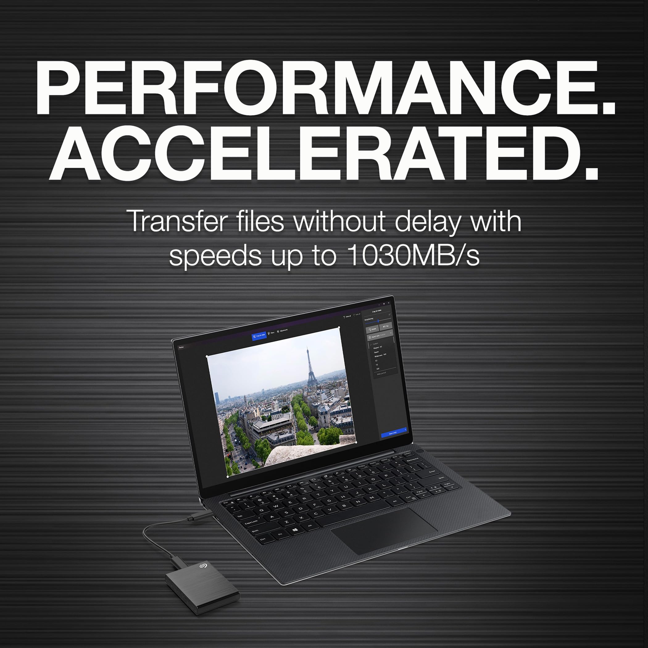 Seagate 1TB SSD with Adobe Creative Cloud connected to laptop showing high-speed file transfer