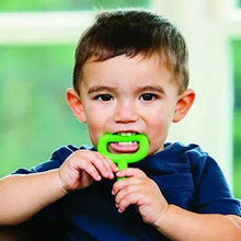 Green chewy tube held by a child in a dark blue shirt