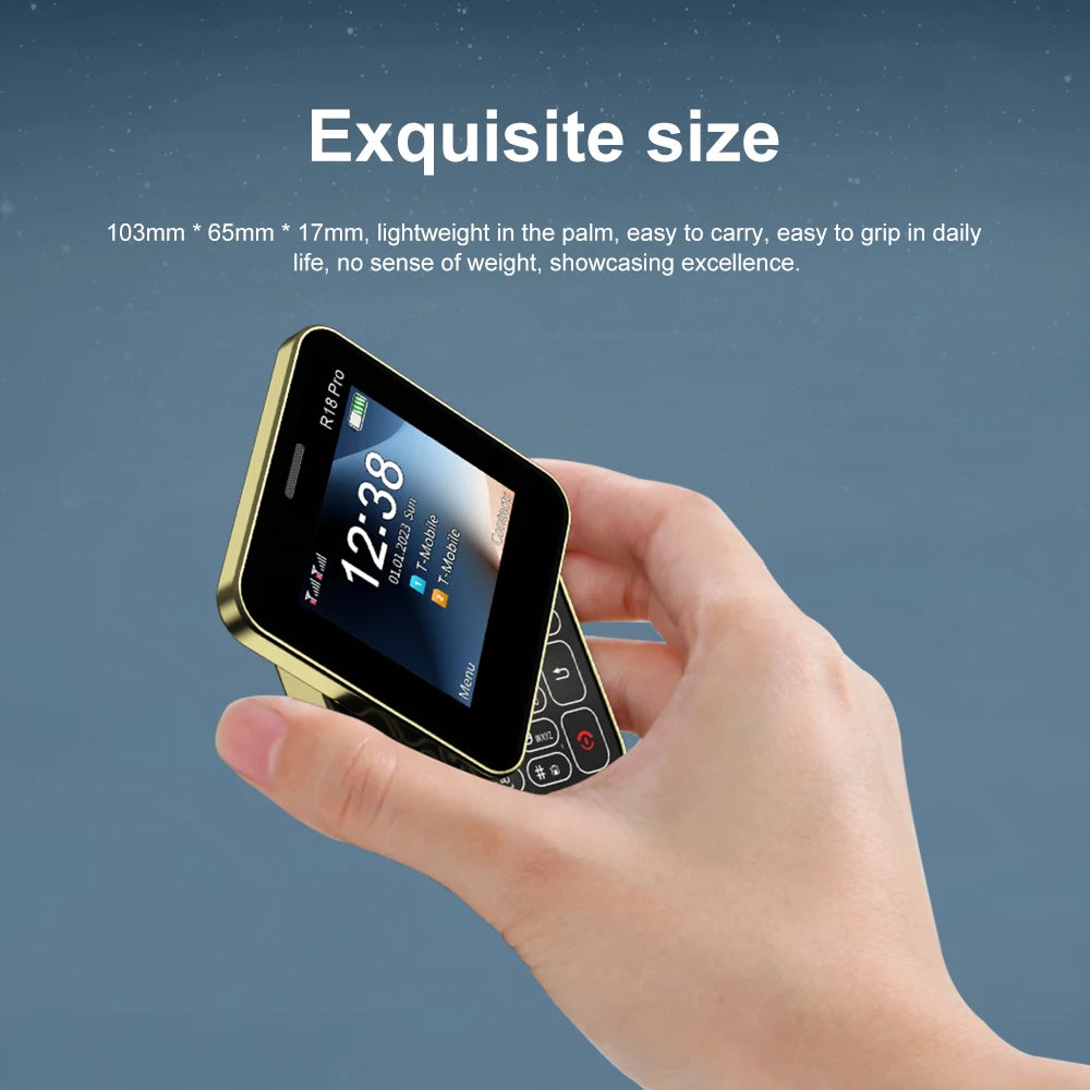 Hand holding gold trimmed SERVO R18 PRO side slider phone with numeric keypad and small display