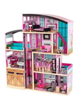 Multi-level dollhouse with pink, purple, and teal rooms and miniature furniture