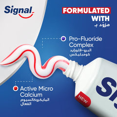 Signal toothpaste tube with red and white striped paste showing Pro Fluoride Complex and Active Micro Calcium fluoride toothpaste for strong teeth