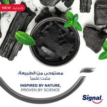 Charcoal whitening toothpaste concept with dark charcoal in a bowl and mint leaves