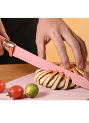 Huitich 19 piece kitchen tool set UAE with pink serrated knife cutting bread on wooden board