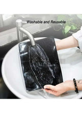 Black silicone dashboard anti-skid mat being rinsed, textured non-slip surface