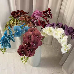 Colorful silk artificial floral decor arrangement in white vase by Huitich with vibrant orchid blooms
