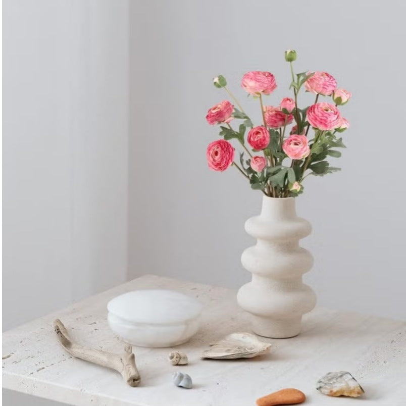 Huitich silk rose flower bouquet with pink artificial flowers in a white sculpted vase on a stone table