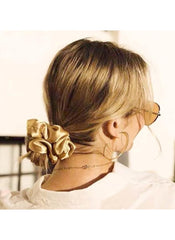 Huitich gold silk scrunchie for women worn on low bun hairstyle with gold hoop earrings