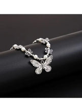 Silver butterfly pendant necklace with pearl beads and leaf charm accents