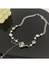 Silver-tone charm necklace featuring round cabochon beads and a crown center charm