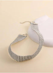 Silver crystal rhinestone choker necklace with adjustable chain from hutich on beige background