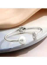 Silver cuff bracelet with hinge clasp, white pearl, and crystal band details