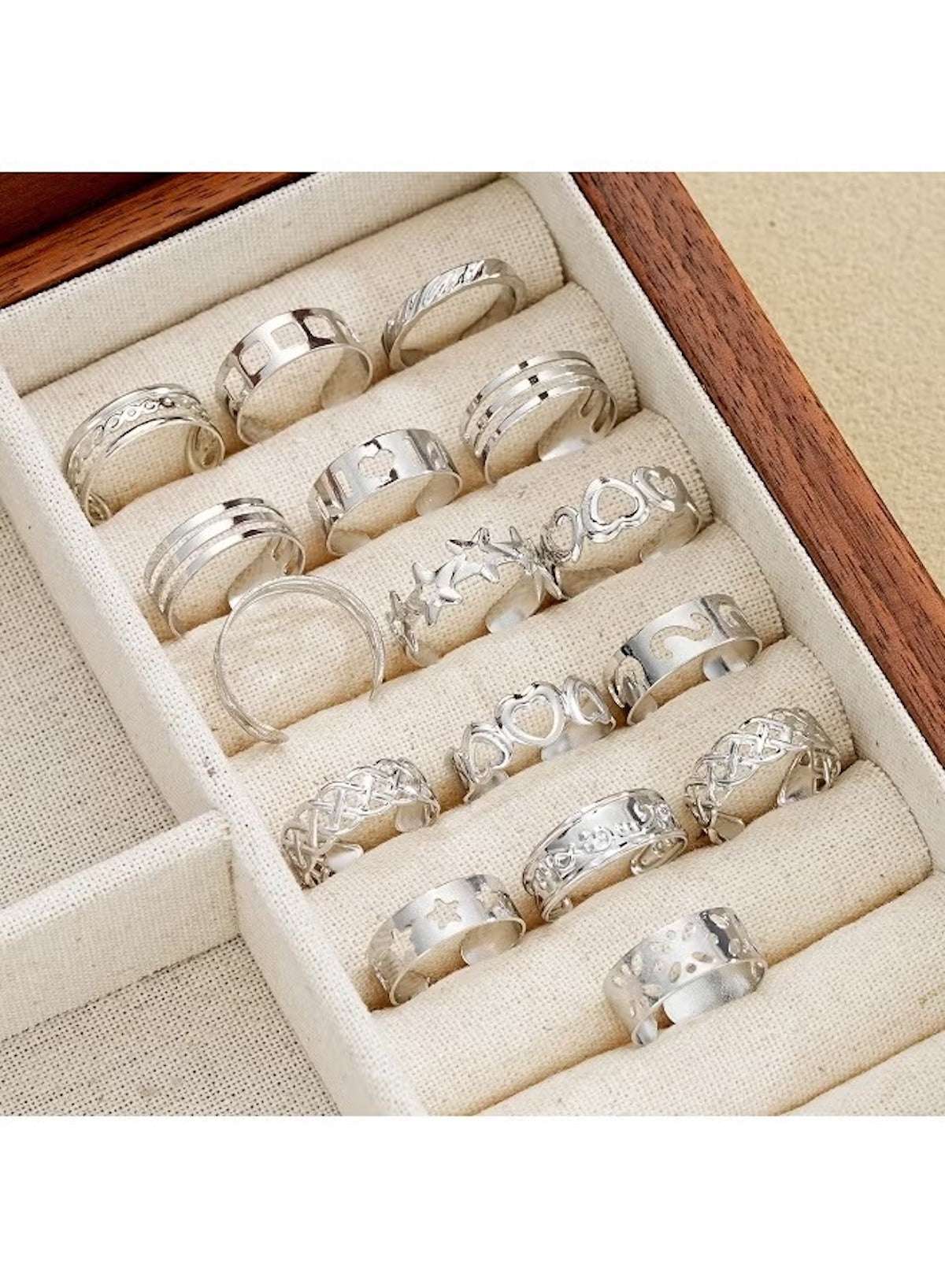 Elegant silver ring set for women featuring various designs in a stylish wooden display box