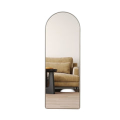 Huitich silver standing mirror for bedroom with arched top reflecting a beige sofa and wooden floor