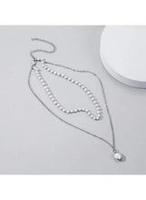 Silver tone multi strand necklace with pearl beads and round drop charm