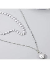 Silver tone necklace with pearl bead strand and round pendant charm