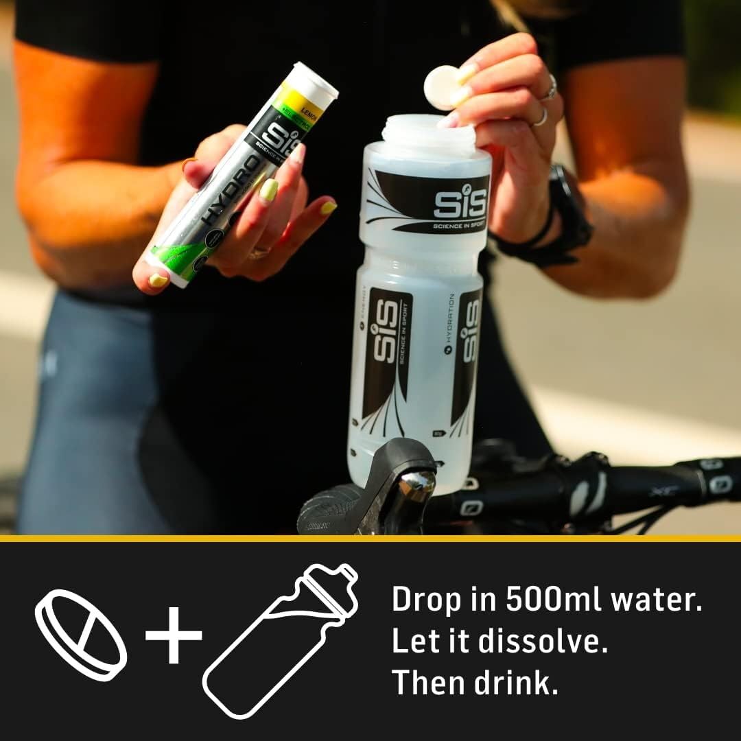 Science in Sport athlete dropping electrolyte tablets for hydration into SiS cycling water bottle on road ride