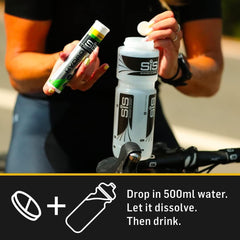 Science in Sport athlete dropping electrolyte tablets for hydration into SiS cycling water bottle on road ride