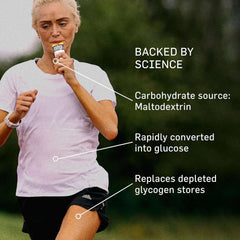 Woman runner in pink shirt consuming Science in Sport isotonic energy gels for runners while jogging outdoors