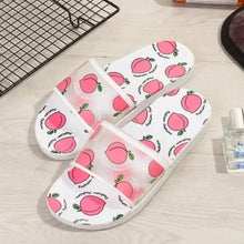 White slip-on sandals with peach pattern, open toe and small side cutouts